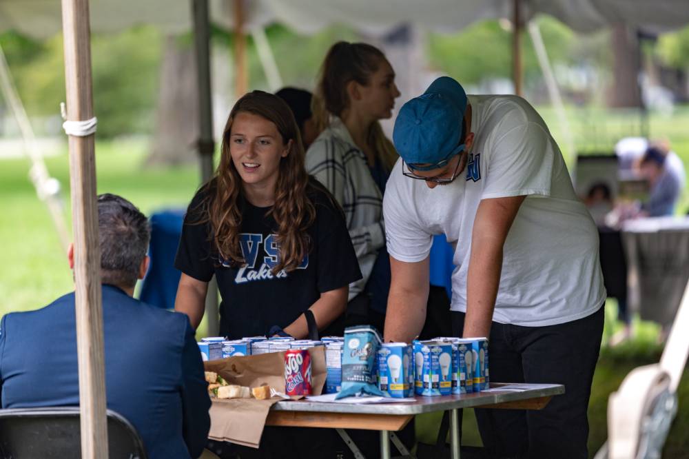 male and female gvsu students talking at a community table